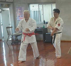 Receiving instructions from former Okinawa Shorinryu Karatedo Kyokai President, Takeshi Miyagi, Hanshi